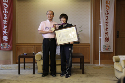 銀メダルを手に石川選手と記念撮影する二井知事