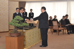 勲記と勲章を手渡す村岡知事の写真