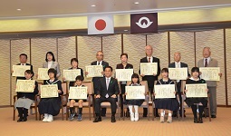 受賞者と記念撮影する村岡知事の写真